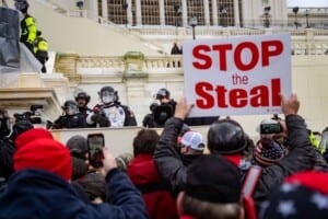 Photo of rioters with a "Stop the Steal" banner